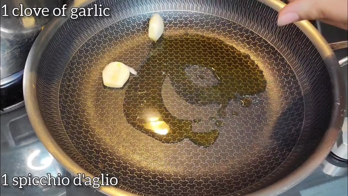 Heat olive oil in a pan. Add chopped garlic to the pan.