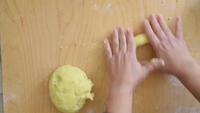 Roll walnut-sized pieces of dough into long ropes. Cut into desired shapes (small squares for fluffy, slightly longer pieces for chunky).