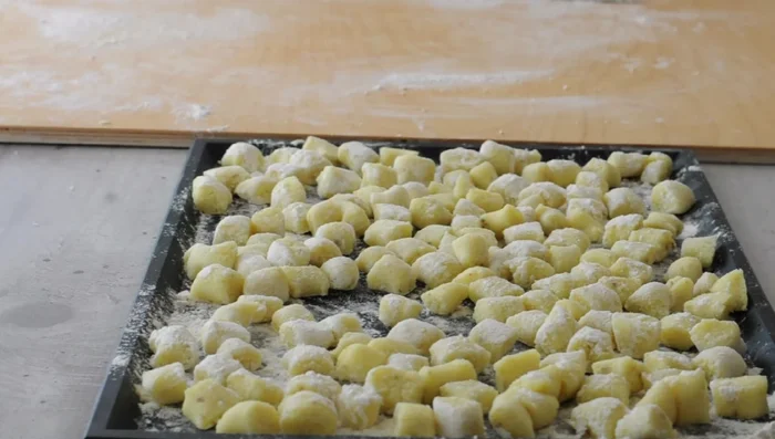 Arrange gnocchi on lightly floured trays, leaving space between each. Indent larger gnocchi with a fork (optional). Dust generously with flour.