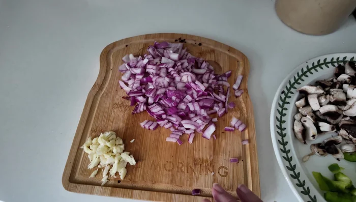 Sauté onions in a pan, add garlic for a minute, then add mushrooms and peppers. Stir and cook for about 4 minutes.