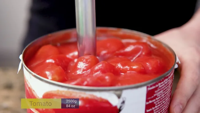 Blend the tomatoes using an immersion blender.