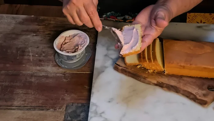 Spread whipped cream cheese on one slice of pound cake, top with another slice to make a sandwich. Cut in half for finger foods. Refrigerate.