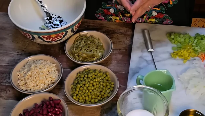 Drain and rinse all beans for the salad. Dice celery and bell pepper, thinly slice onion and pepperoncini peppers (optional).