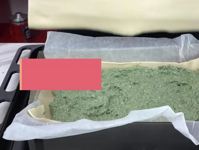 Cover with the second sheet of puff pastry and seal the edges.