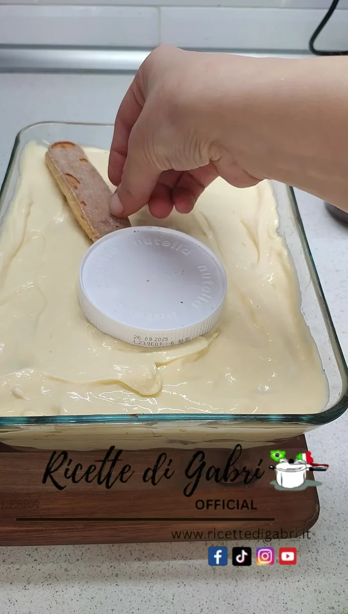 Place two ladyfingers (cut shorter if desired) and two forks (or breaking snacks) on top of the tiramisu.