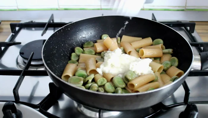 Stir in the Pecorino cheese and more pasta water to create a creamy sauce.