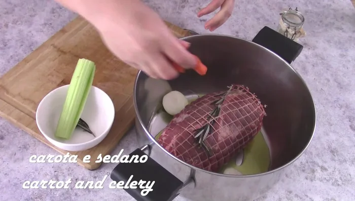 Brown a 1kg roast in a pan with oil, onion, carrot, and celery.
