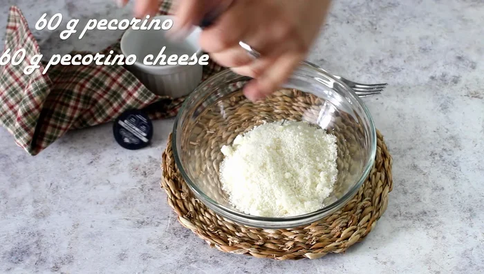 While pasta cooks, grate 60g of Pecorino Romano cheese, add pepper.