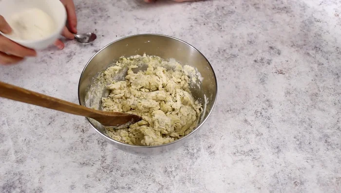Turn the dough out onto a lightly floured surface and knead until smooth and elastic.