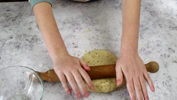 Roll out the dough thinly on a lightly floured surface.
