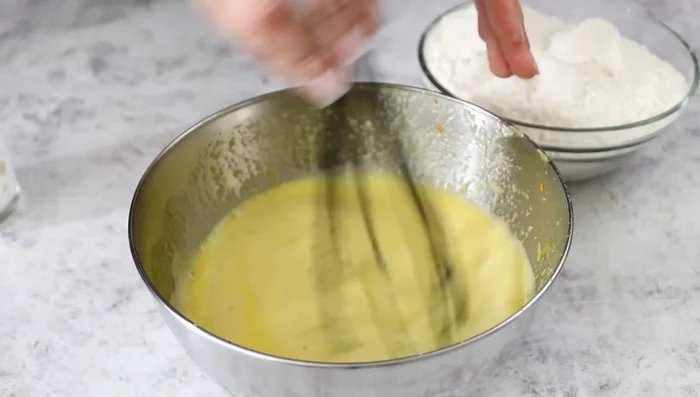 Gradually add flour to the egg mixture, mixing until a thick dough forms. Knead with a fork, then on a floured surface for at least 5 minutes (or use a mixer).