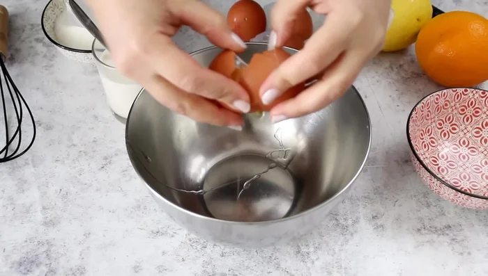 In a bowl, whisk together eggs, yolks, sugar, vanilla, lemon and orange zest.