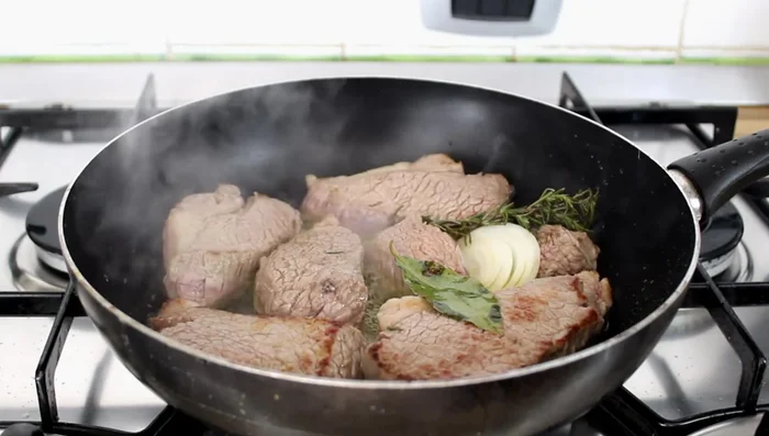 Deglaze the pan with 80ml of red wine, allowing the alcohol to evaporate.