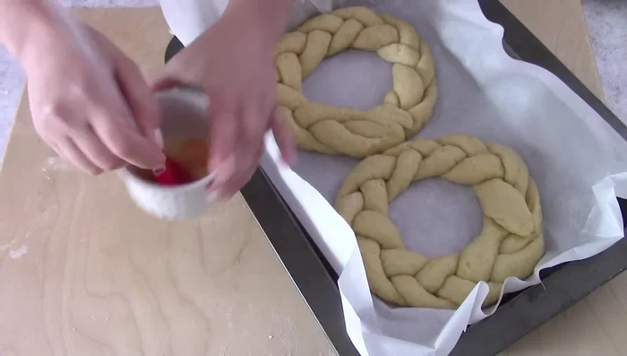 Brush with egg yolk and milk, sprinkle with sugar, and bake.