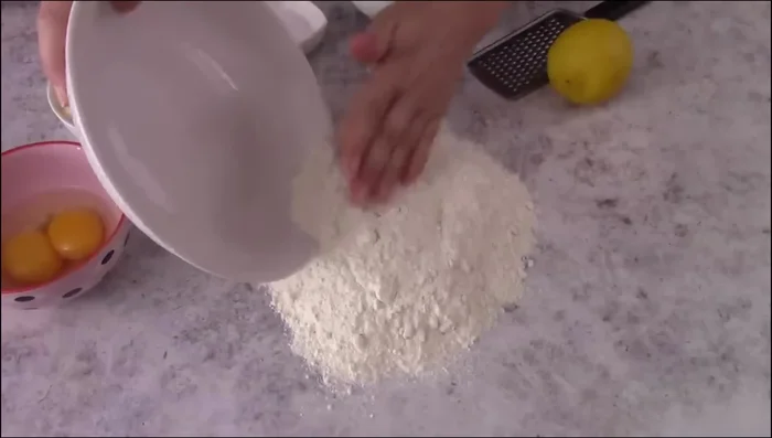 Prepare shortcrust pastry: Mix flour, butter, sugar, salt, and lemon zest. Add egg and yolk, knead until smooth. Refrigerate for at least 1 hour.