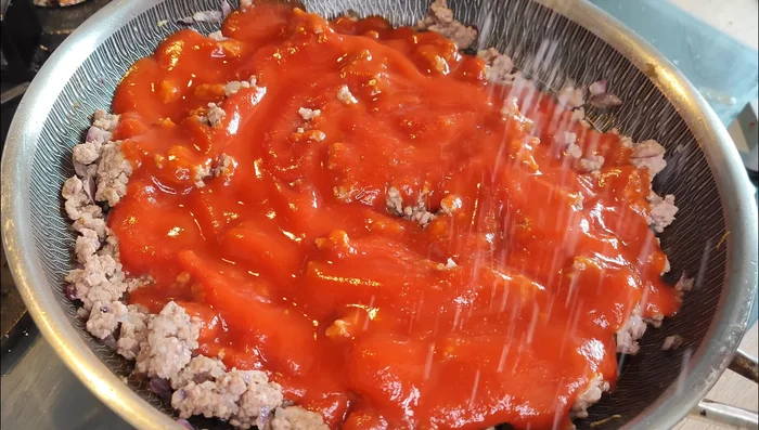 Prepare the tomato sauce: Sauté garlic in olive oil. Add tomato sauce, salt and pepper to taste. Simmer for 15-20 minutes.