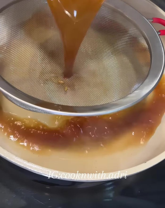 Strain the gravy: Strain the gravy into a larger pan.