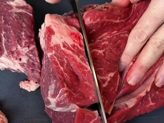 Remove any large fat pieces from the chuck roast and chop it into large chunks (for faster cooking).