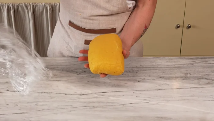 Once rested, cut a portion of the dough, keeping the rest covered to prevent drying.