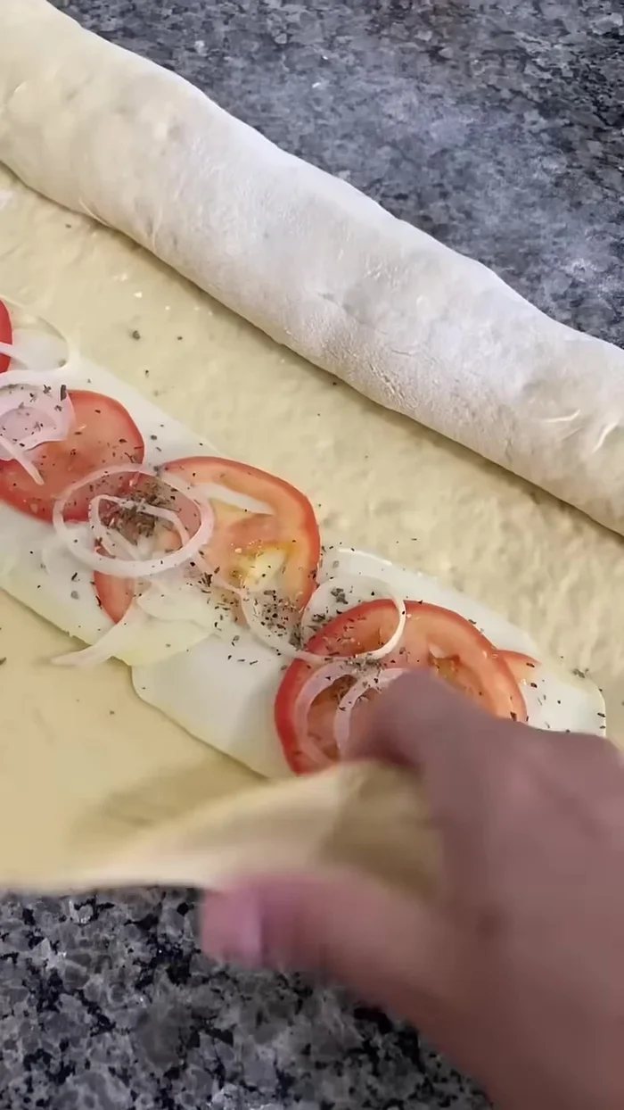 Fold the dough over to enclose the filling. (See video for folding technique).
