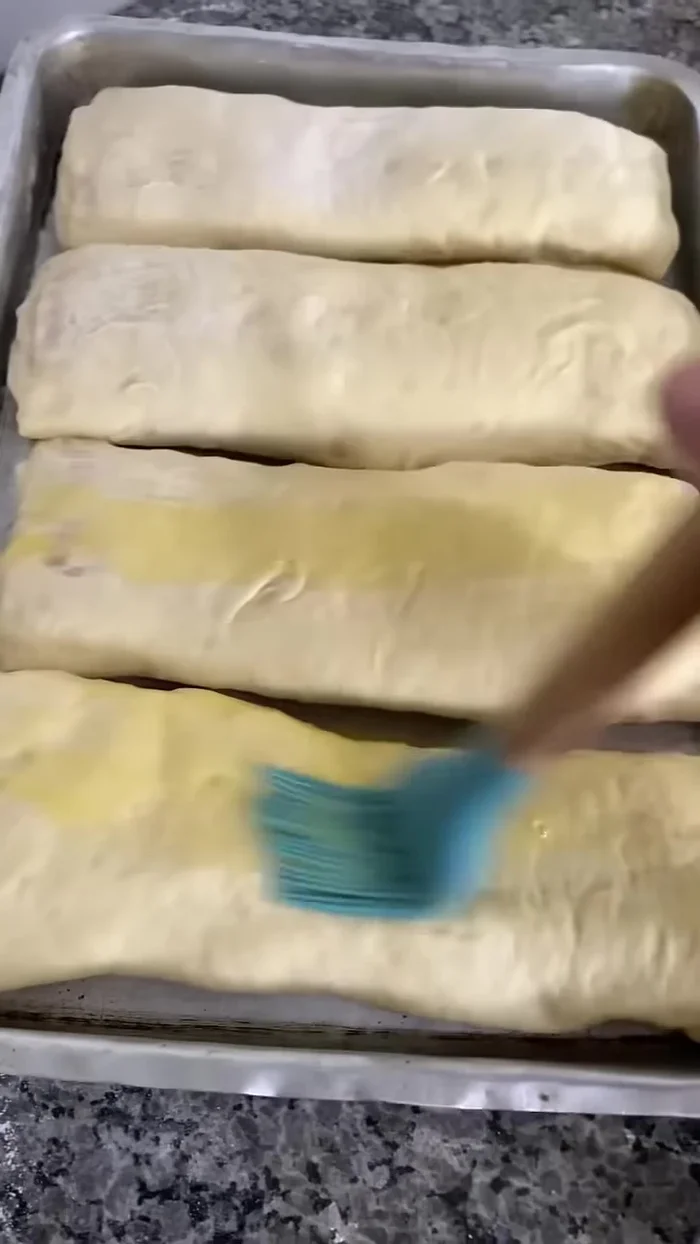 Brush the loaves with beaten egg yolk and sprinkle with oregano.