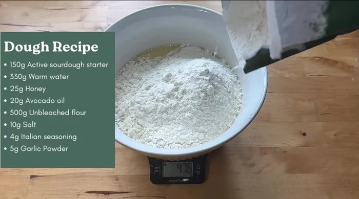 Add 500g flour, 10g salt, 4g Italian seasoning, and 2g garlic powder to the wet ingredients. Mix until a shaggy dough forms.
