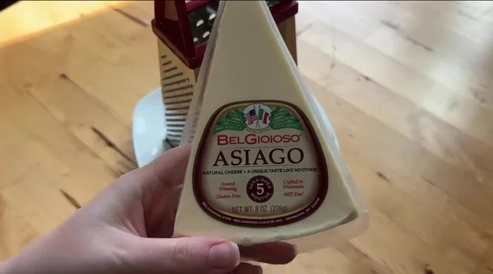 Grate 80g of cheese (40g Asiago, 40g Parmesan).