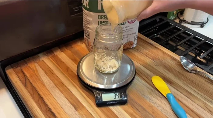 Feed your sourdough starter the night before. Mix 60g starter, 60g flour, and 60g water until no dry clumps remain. Cover loosely and mark the level to track doubling.