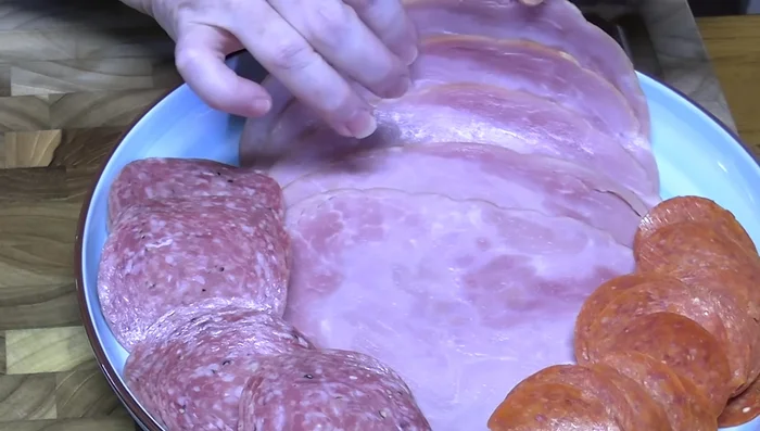 Chop ham, salami, and pepperoni into small pieces.