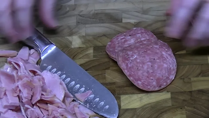 Slice provolone cheese into thin strips and chop into smaller pieces.