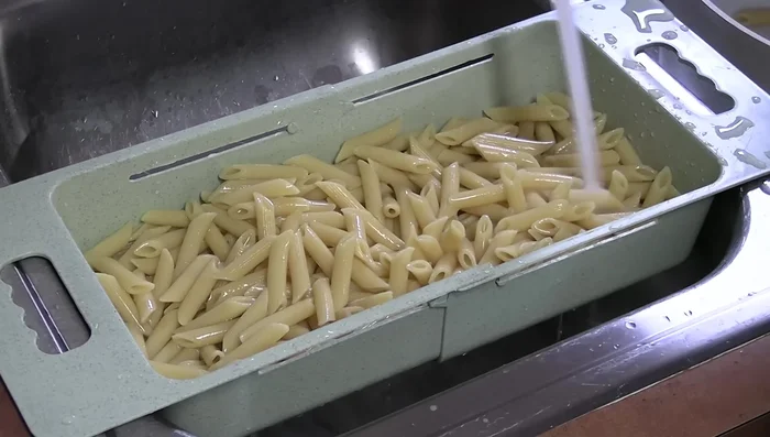 Cool the pasta by running cold water over it. Blot with paper towels to remove excess water.