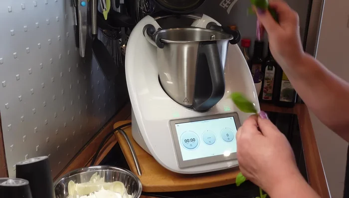 Add the basil leaves to the bowl.