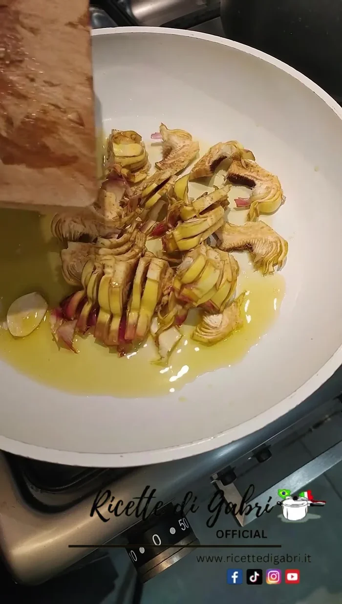In a pan, sauté the artichoke slices with olive oil, a halved clove of garlic, salt, and pepper.