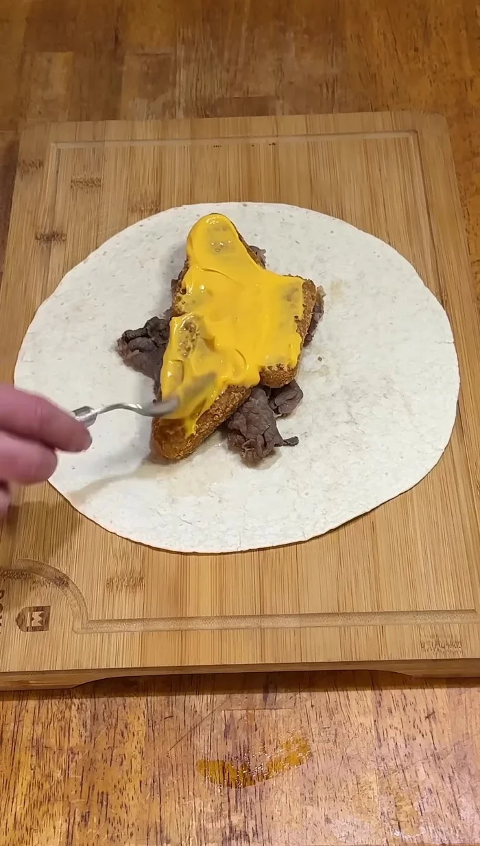 Coat the potato cakes with Arby's cheese sauce and red ranch dressing.