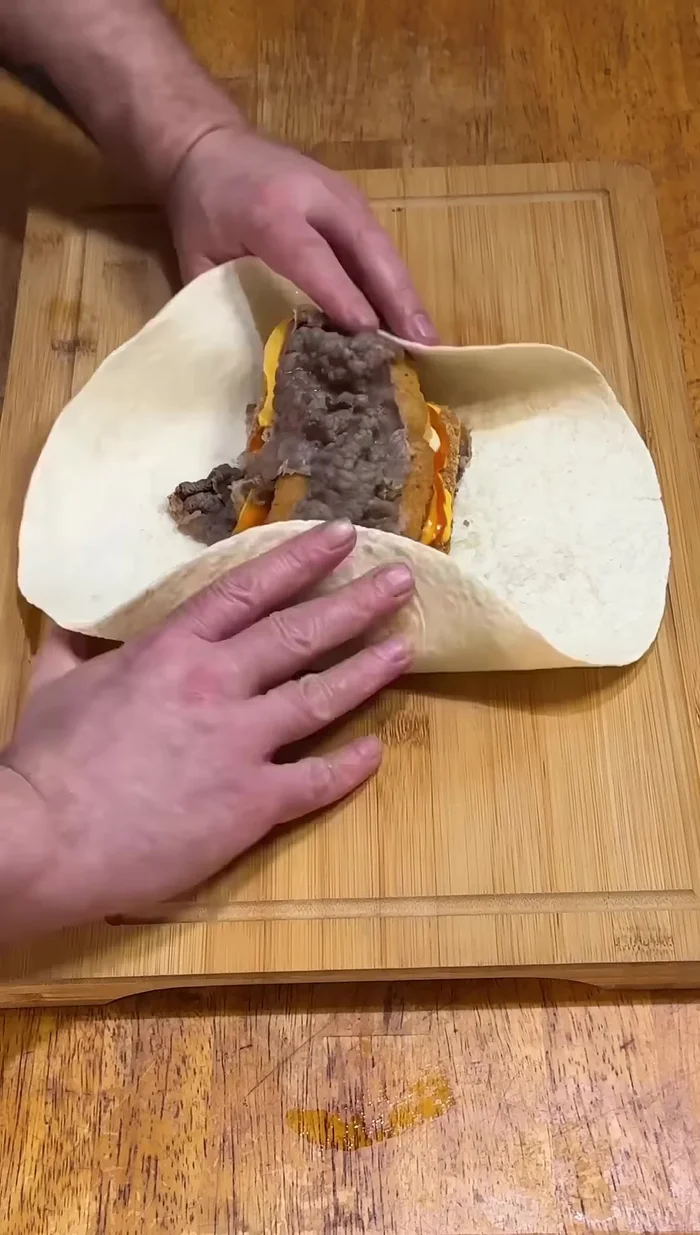 Carefully roll up the burrito, ensuring the tortilla doesn't break.