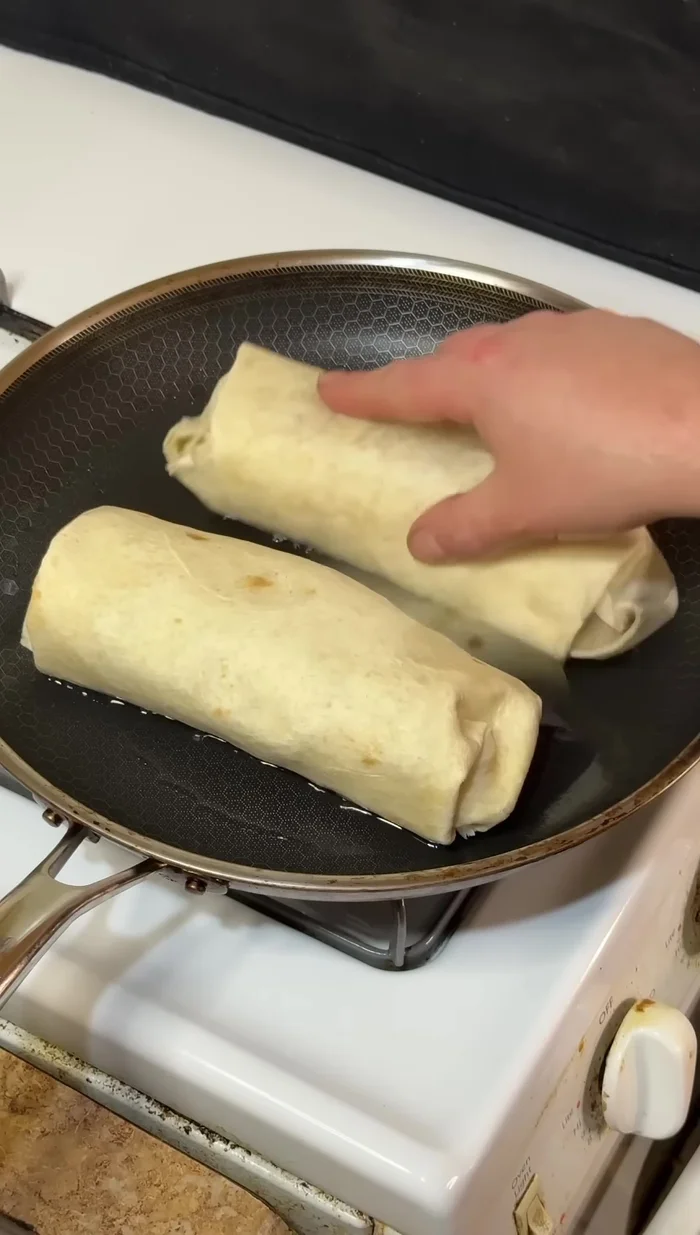 Cook the burrito in a pan on medium-high heat until crispy on all sides.