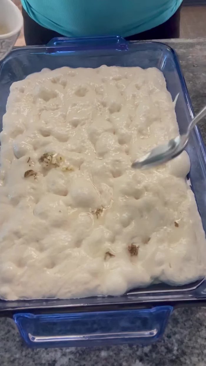 Prepare ficaccia bread dough the night before. Add olive oil, herbs, and shredded parmesan cheese.