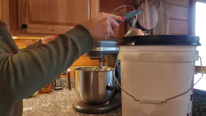 Gradually add the dry ingredients to the wet ingredients, using a KitchenAid mixer on speed 2. Add more flour as needed until the dough pulls away from the sides of the bowl.