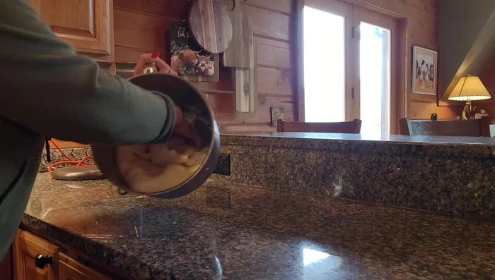 Punch down the risen dough and turn it out onto a lightly floured surface.