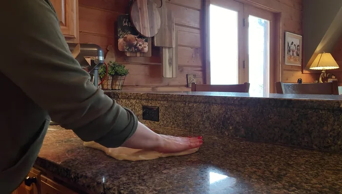 Shape the dough into a rectangle, flip it over, and tuck the edges to form a loaf.