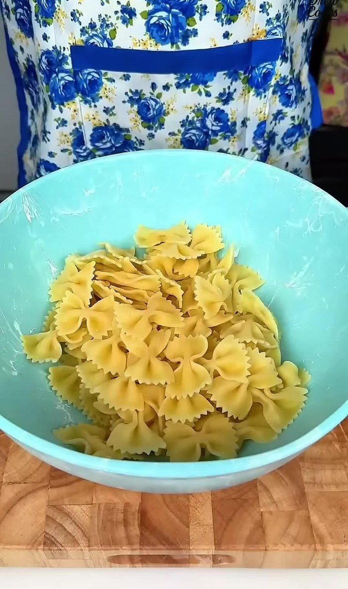 Add 8 ounces of cooked bow tie pasta to a mixing bowl.