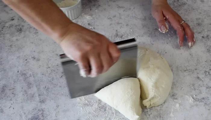 Divide and shape the dough: Divide the risen dough into four equal parts and shape each into a ball.