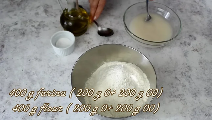 Mix the flour: Combine 400g of flour (half 00, half double zero) with the yeast mixture, 2 tablespoons of oil.