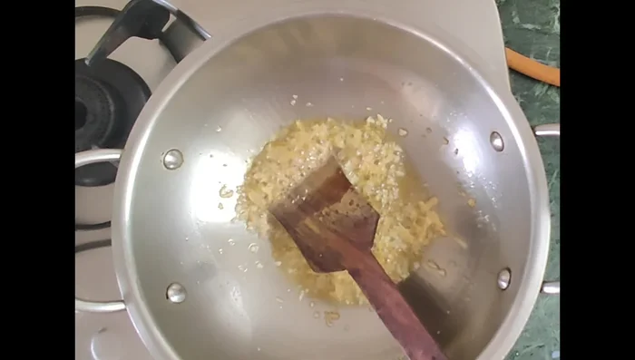 Add chopped onions and capsicums. Fry until the water evaporates.