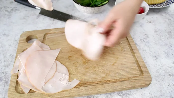 Prepare the turkey roses: Slice the cooked turkey breast into thirds and roll each slice to form a rose.