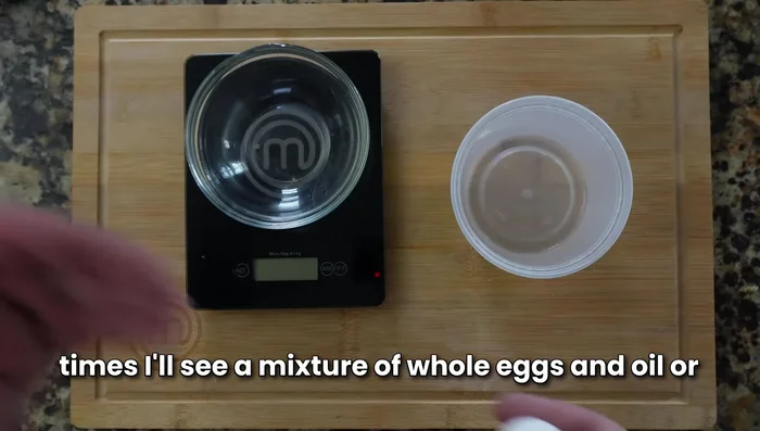 In a separate bowl, whisk together egg yolks and water.