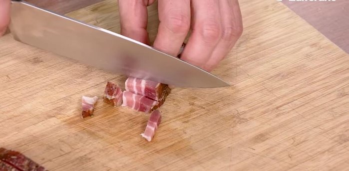 Cut the rest of the bacon into thin strips and add it to the sauté. Allow it to brown and flavor it with chopped rosemary. Cook for a few minutes.