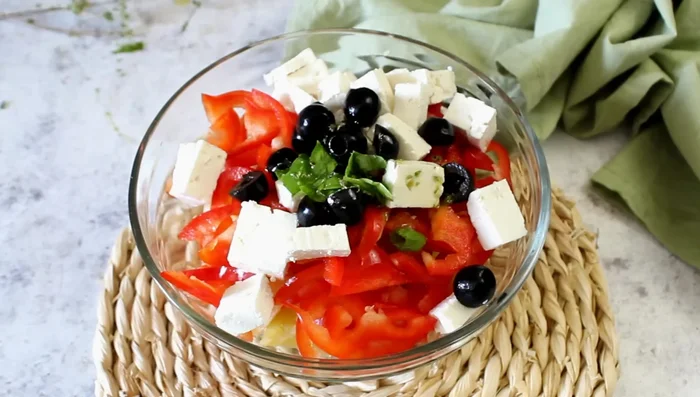 Dress the potato, feta, and pepper salad.