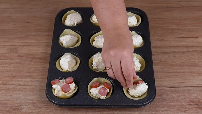 Add 3 slices of smoked sausage to each shell.
