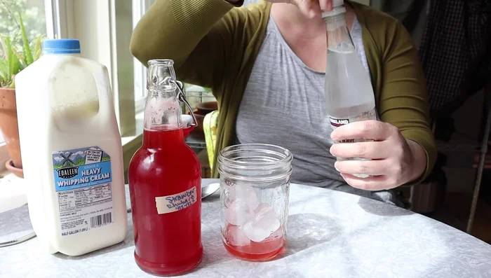 Add sparkling water to the glass.